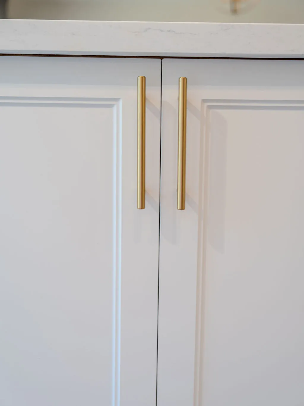 Stylish cabinet hardware options displayed on a wooden surface, highlighting affordable upgrades for kitchen cabinets