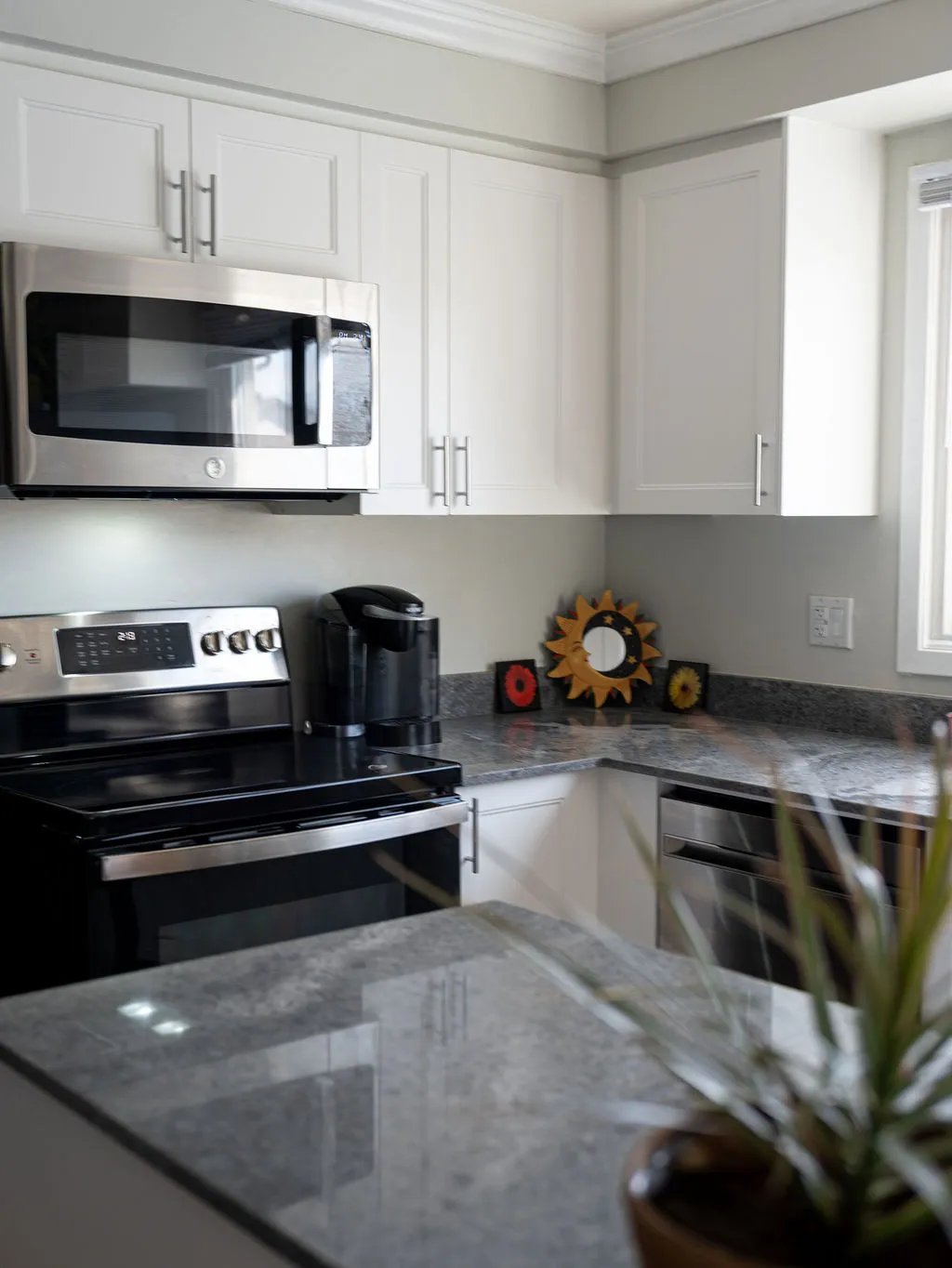 Professional installing granite countertop with tools in a modern kitchen setting